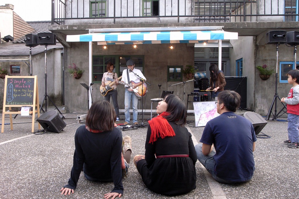 Teenagers enjoying buskers' music at 44 South Village