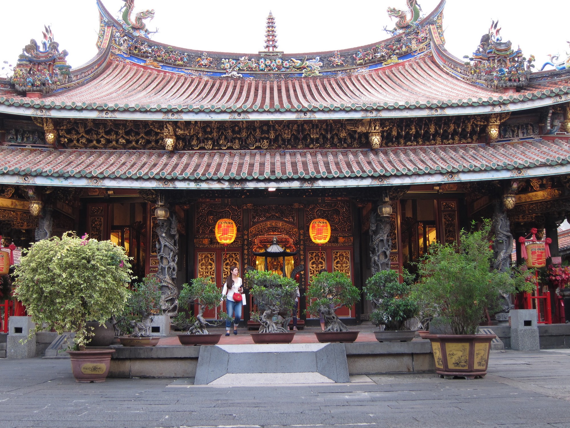 Lady exiting the temple at Dalongdong Cultural and Historical District
